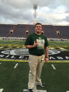 ryan lysaght standing on football field